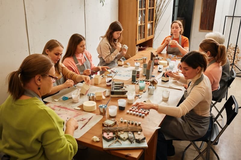 A group at a craft workshop table, making things together